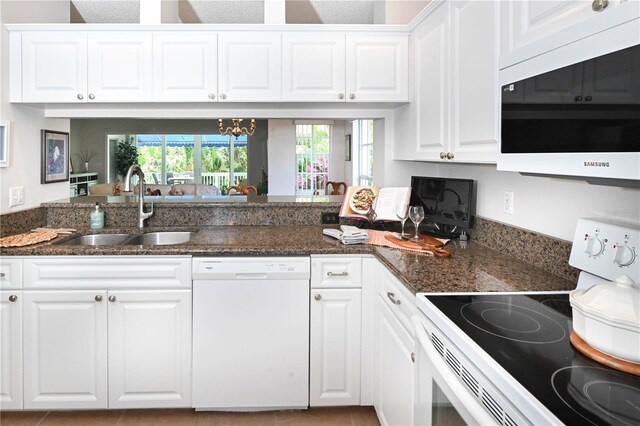 14840 Shipwatch Trce Unit 1924, Largo, FL 33774 - kitchen featuring white appliances, a sink, and white cabinets