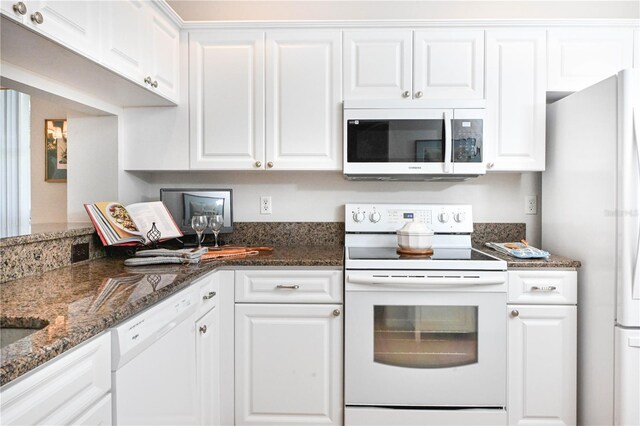 14840 Shipwatch Trce Unit 1924, Largo, FL 33774 - kitchen with white appliances, white cabinetry, and dark stone counters