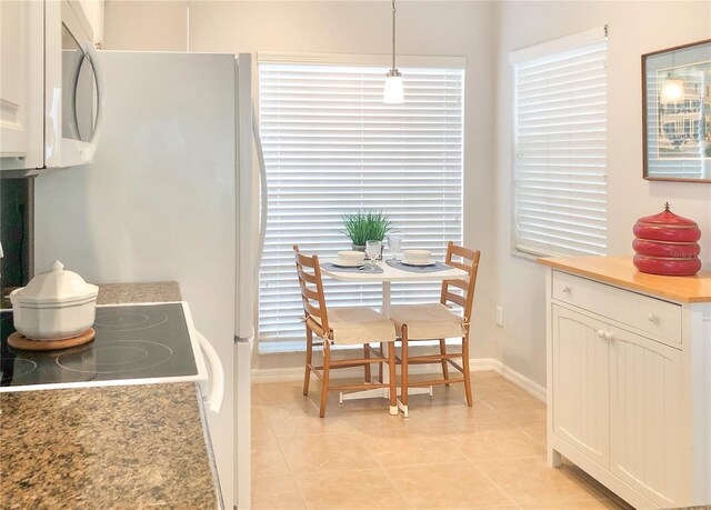 14840 Shipwatch Trce Unit 1924, Largo, FL 33774 - dining area featuring baseboards and light tile patterned floors