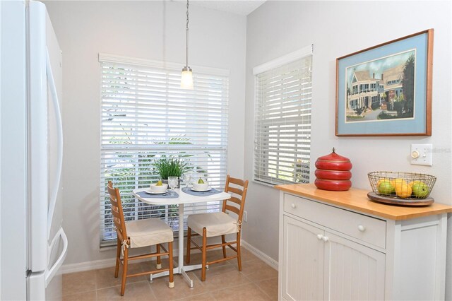14840 Shipwatch Trce Unit 1924, Largo, FL 33774 - dining room with plenty of natural light, baseboards, and light tile patterned floors