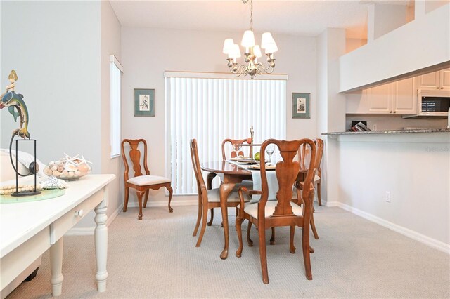 14840 Shipwatch Trce Unit 1924, Largo, FL 33774 - dining space featuring a chandelier, light carpet, and baseboards