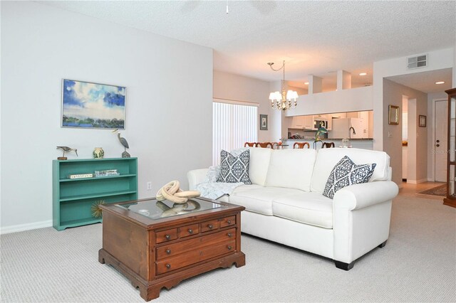 14840 Shipwatch Trce Unit 1924, Largo, FL 33774 - living area featuring light colored carpet, a chandelier, a textured ceiling, baseboards, and recessed lighting