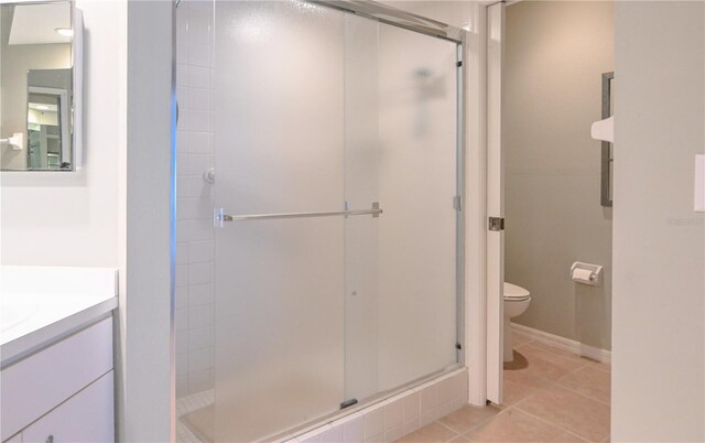 14840 Shipwatch Trce Unit 1924, Largo, FL 33774 - bathroom with toilet, vanity, a shower stall, and tile patterned flooring