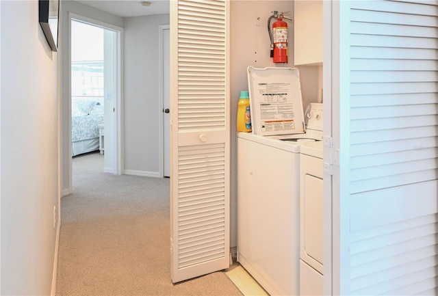 14840 Shipwatch Trce Unit 1924, Largo, FL 33774 - washroom featuring washer and clothes dryer, light carpet, and baseboards