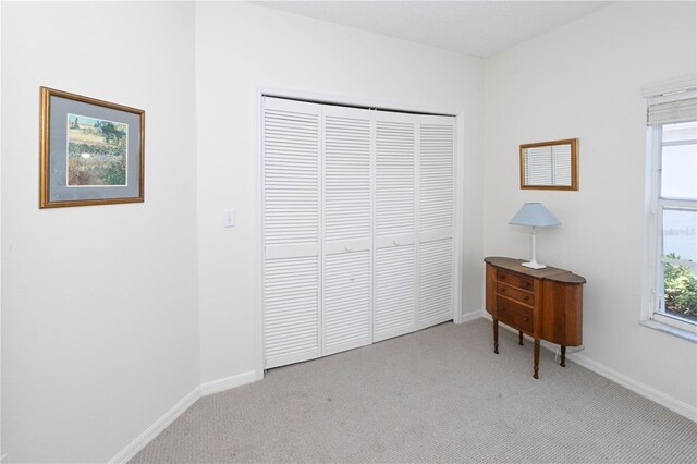 14840 Shipwatch Trce Unit 1924, Largo, FL 33774 - carpeted bedroom with a closet, baseboards, and multiple windows