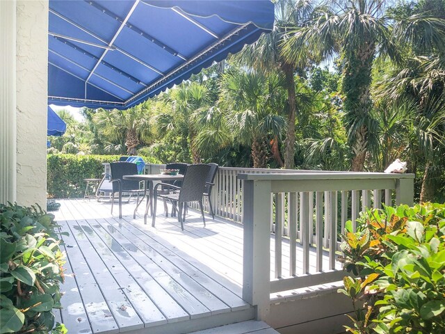 14840 Shipwatch Trce Unit 1924, Largo, FL 33774 - wooden deck with outdoor dining space