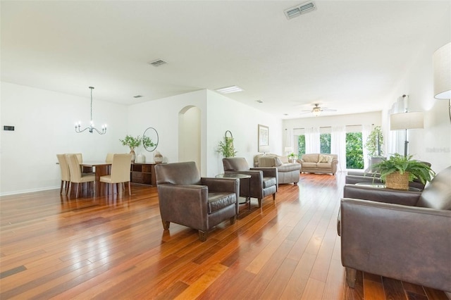 20403 Sultana Ct, Tampa, FL 33647 - living room with arched walkways, hardwood / wood-style floors, a chandelier, and ceiling fan
