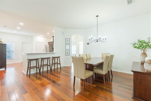 20403 Sultana Ct, Tampa, FL 33647 - dining space featuring arched walkways, wood-type flooring, baseboards, a chandelier, and recessed lighting