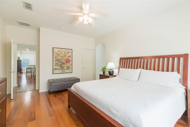 20403 Sultana Ct, Tampa, FL 33647 - bedroom with light wood-style flooring, arched walkways, and ceiling fan