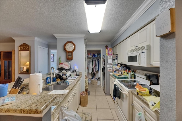 9481 Highland Oak Dr Unit 1511, Tampa, FL 33647 - kitchen featuring white appliances, a sink, light tile patterned flooring, a textured ceiling, and white cabinetry