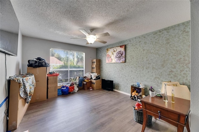 9481 Highland Oak Dr Unit 1511, Tampa, FL 33647 - playroom featuring wood finished floors, ceiling fan, a textured ceiling, and baseboards