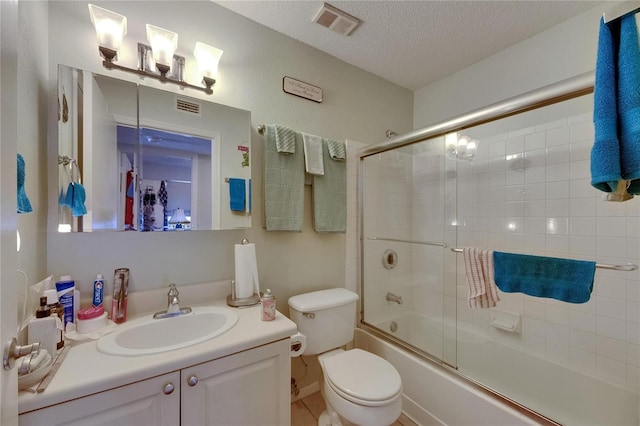 9481 Highland Oak Dr Unit 1511, Tampa, FL 33647 - bathroom with vanity, shower / bath combination with glass door, toilet, and a textured ceiling