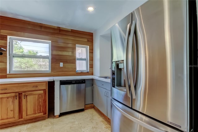 1242 Bermuda St, Clearwater, FL 33755 - kitchen featuring stainless steel appliances, light countertops, wooden walls, recessed lighting, and light tile patterned flooring