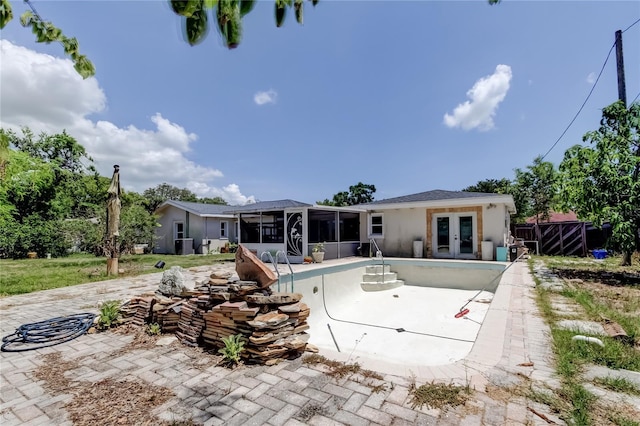 1242 Bermuda St, Clearwater, FL 33755 - back of house with french doors, a sunroom, stucco siding, and a patio area
