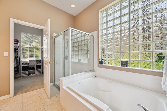 5704 Eaglemount Cir, Lithia, FL 33547 - full bathroom featuring a stall shower, a walk in closet, a garden tub, and tile patterned flooring