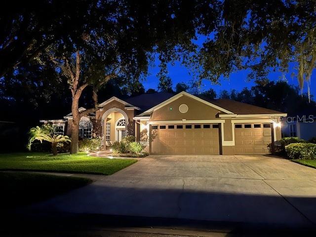 5704 Eaglemount Cir, Lithia, FL 33547 - single story home featuring a garage, stucco siding, driveway, and a lawn