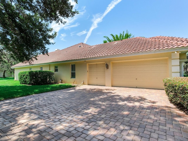 10504 Echo Lake Dr, Odessa, FL 33556 - view of front of property featuring stucco siding, decorative driveway, a garage, and a tiled roof