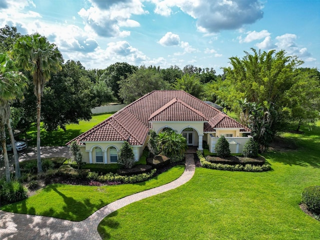 10504 Echo Lake Dr, Odessa, FL 33556 - mediterranean / spanish house featuring stucco siding, a tiled roof, and a front lawn