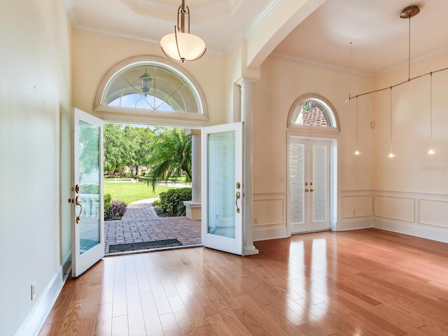 10504 Echo Lake Dr, Odessa, FL 33556 - entryway featuring arched walkways, french doors, ornamental molding, wood finished floors, and a towering ceiling