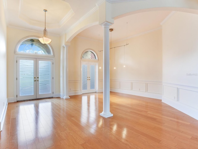 10504 Echo Lake Dr, Odessa, FL 33556 - entryway with french doors, ornate columns, arched walkways, ornamental molding, and light wood-style flooring