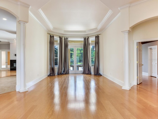 10504 Echo Lake Dr, Odessa, FL 33556 - unfurnished room featuring ornate columns, baseboards, light wood-type flooring, arched walkways, and ornamental molding