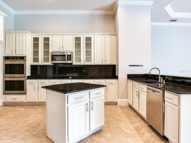 10504 Echo Lake Dr, Odessa, FL 33556 - kitchen with stainless steel appliances, crown molding, decorative backsplash, a peninsula, and a center island