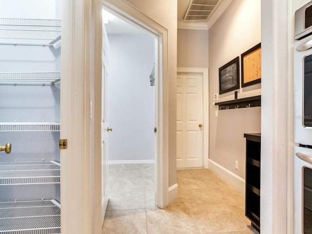 10504 Echo Lake Dr, Odessa, FL 33556 - hallway with light tile patterned flooring, crown molding, and baseboards
