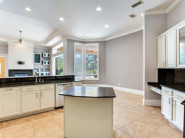 10504 Echo Lake Dr, Odessa, FL 33556 - kitchen featuring a sink, stainless steel dishwasher, crown molding, dark stone counters, and a center island