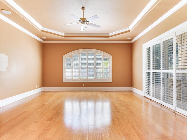 10504 Echo Lake Dr, Odessa, FL 33556 - spare room featuring a raised ceiling, wood finished floors, ceiling fan, ornamental molding, and baseboards