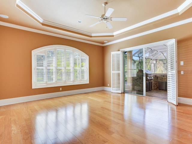 10504 Echo Lake Dr, Odessa, FL 33556 - unfurnished room featuring a raised ceiling, crown molding, wood finished floors, ceiling fan, and baseboards
