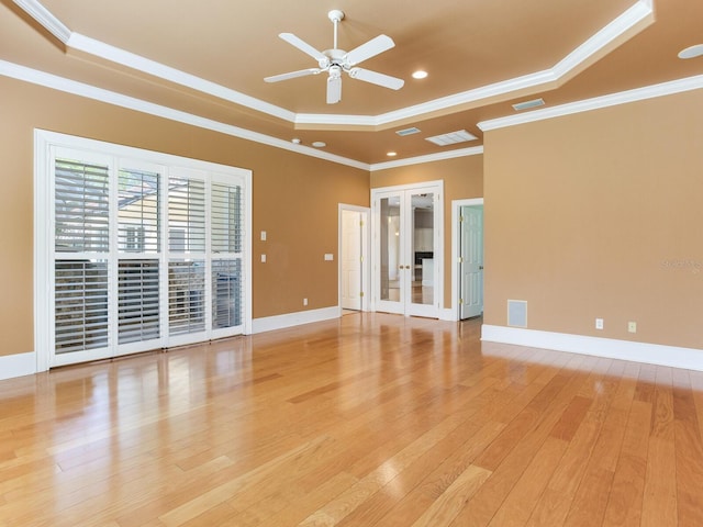 10504 Echo Lake Dr, Odessa, FL 33556 - unfurnished room with a tray ceiling, light wood-style flooring, a ceiling fan, recessed lighting, and french doors