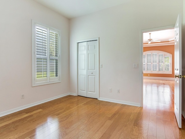 10504 Echo Lake Dr, Odessa, FL 33556 - unfurnished bedroom with light wood-type flooring, baseboards, and a closet