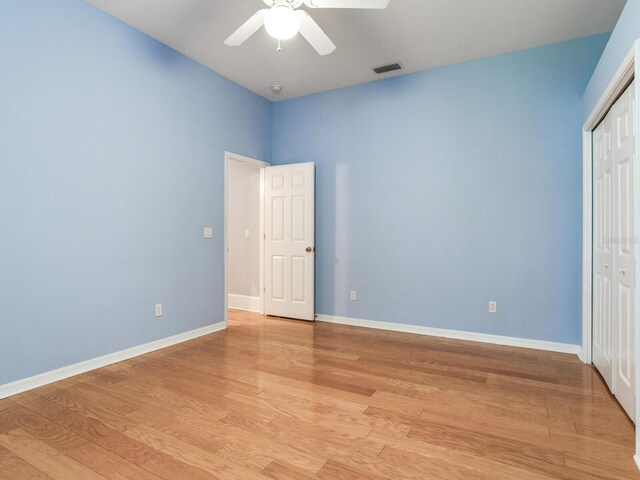 10504 Echo Lake Dr, Odessa, FL 33556 - unfurnished bedroom featuring light wood finished floors, a closet, baseboards, and a ceiling fan