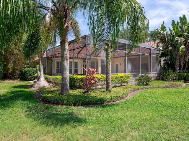 10504 Echo Lake Dr, Odessa, FL 33556 - rear view of house featuring a lawn, stucco siding, and a lanai