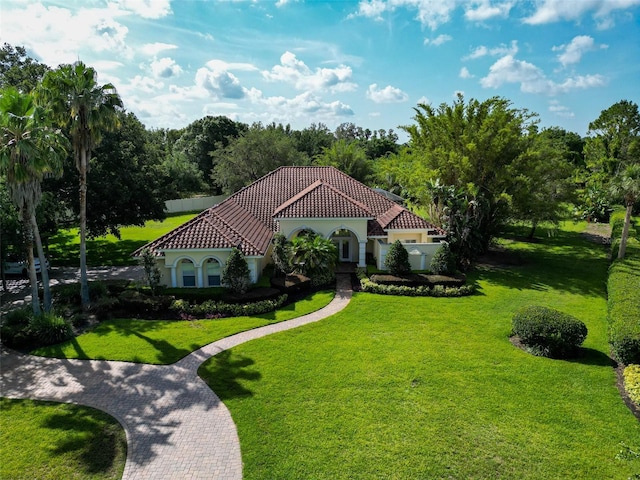 10504 Echo Lake Dr, Odessa, FL 33556 - mediterranean / spanish-style home featuring a tiled roof, a front yard, and stucco siding