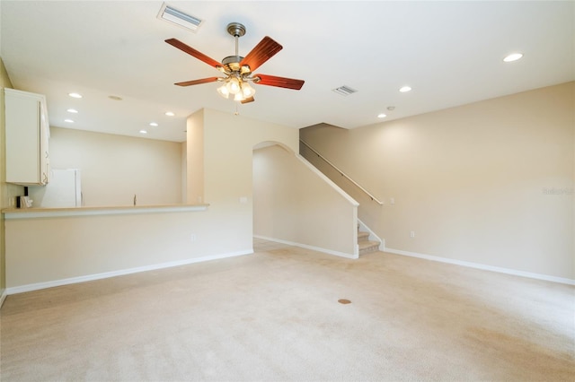 11839 Castine St, New Port Richey, FL 34654 - unfurnished living room featuring light carpet, recessed lighting, baseboards, and stairway