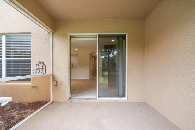 11839 Castine St, New Port Richey, FL 34654 - property entrance with stucco siding and a patio