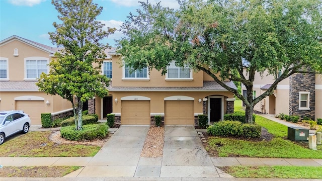 11839 Castine St, New Port Richey, FL 34654 - multi unit property with stucco siding, an attached garage, driveway, and stone siding