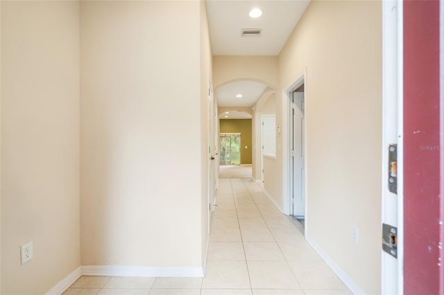 11839 Castine St, New Port Richey, FL 34654 - corridor featuring arched walkways, light tile patterned flooring, recessed lighting, and baseboards