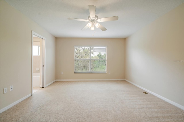 11839 Castine St, New Port Richey, FL 34654 - empty room featuring light colored carpet, ceiling fan, and baseboards