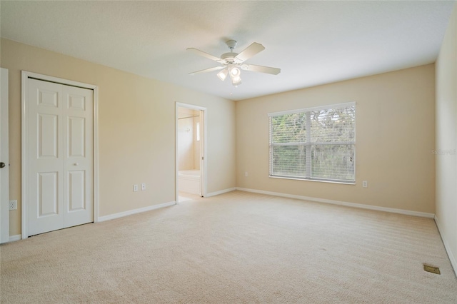 11839 Castine St, New Port Richey, FL 34654 - unfurnished bedroom featuring carpet floors, baseboards, a closet, and ensuite bath
