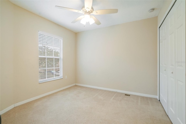 11839 Castine St, New Port Richey, FL 34654 - unfurnished bedroom featuring a closet, light colored carpet, and baseboards