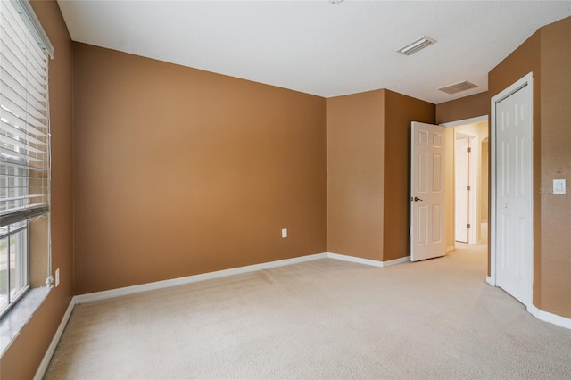 11839 Castine St, New Port Richey, FL 34654 - spare room featuring light carpet and baseboards