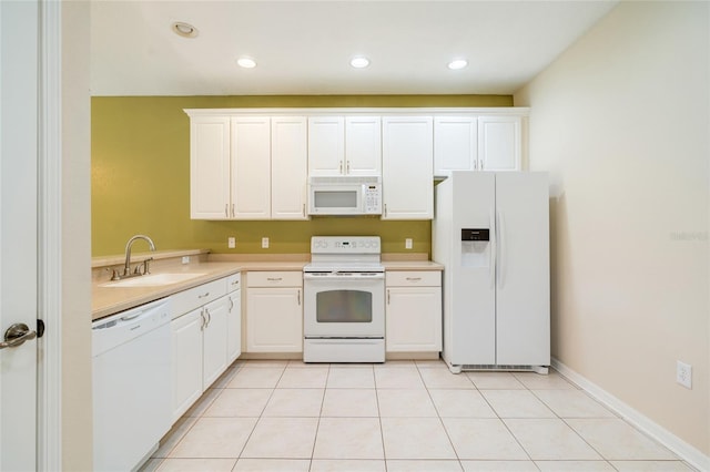 11839 Castine St, New Port Richey, FL 34654 - kitchen featuring white appliances, a sink, light countertops, white cabinets, and recessed lighting