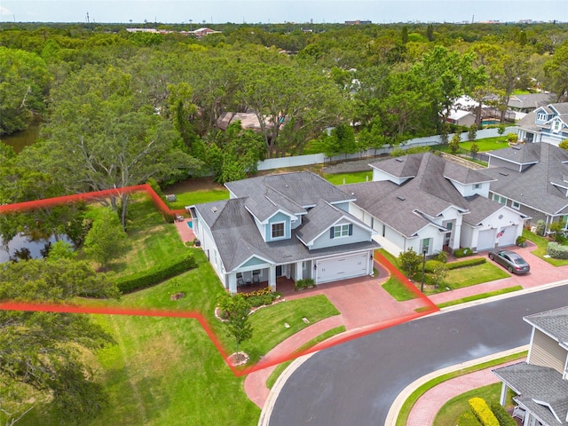 152 Glenn Moor Cir, Dunedin, FL 34698 - aerial view of residential area with property parcel outlined and a forest