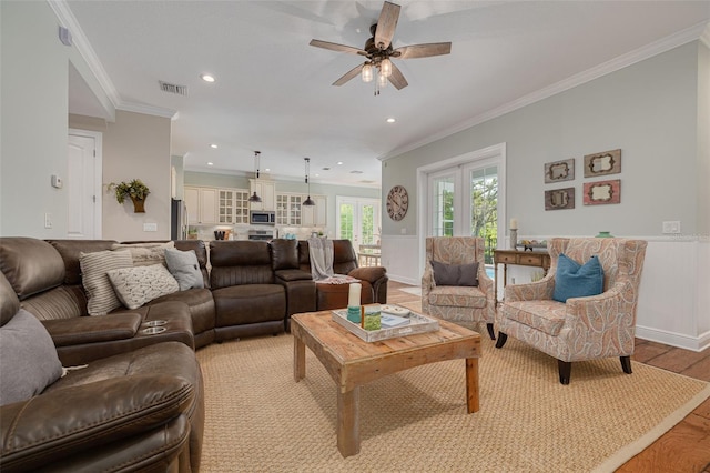 152 Glenn Moor Cir, Dunedin, FL 34698 - living area with light wood finished floors, ceiling fan, ornamental molding, a wainscoted wall, and recessed lighting