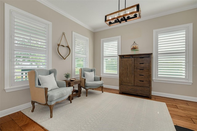 152 Glenn Moor Cir, Dunedin, FL 34698 - living area featuring crown molding, wood finished floors, and baseboards