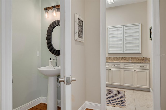 152 Glenn Moor Cir, Dunedin, FL 34698 - bathroom with baseboards, tile patterned floors, and a sink