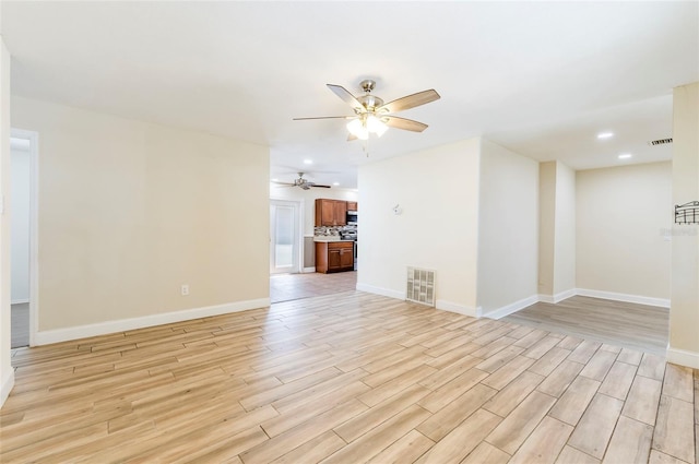 2121 23rd St SW, Largo, FL 33774 - unfurnished living room featuring light wood finished floors, baseboards, a ceiling fan, and recessed lighting