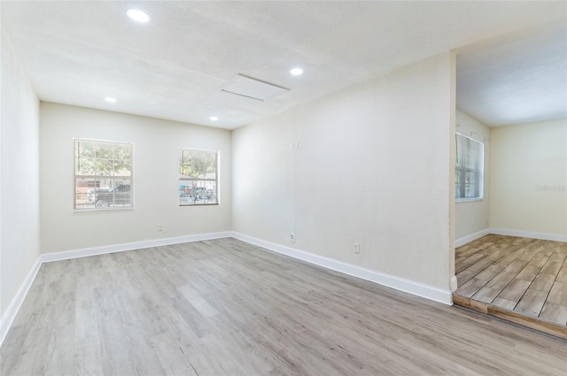 2121 23rd St SW, Largo, FL 33774 - spare room featuring wood finished floors, recessed lighting, baseboards, and attic access
